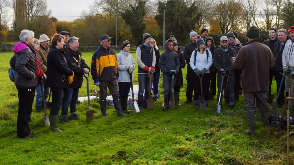 Volunteers prepare to plant trees at Rycote Meadow
